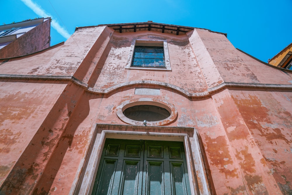 an old building with a green door and window