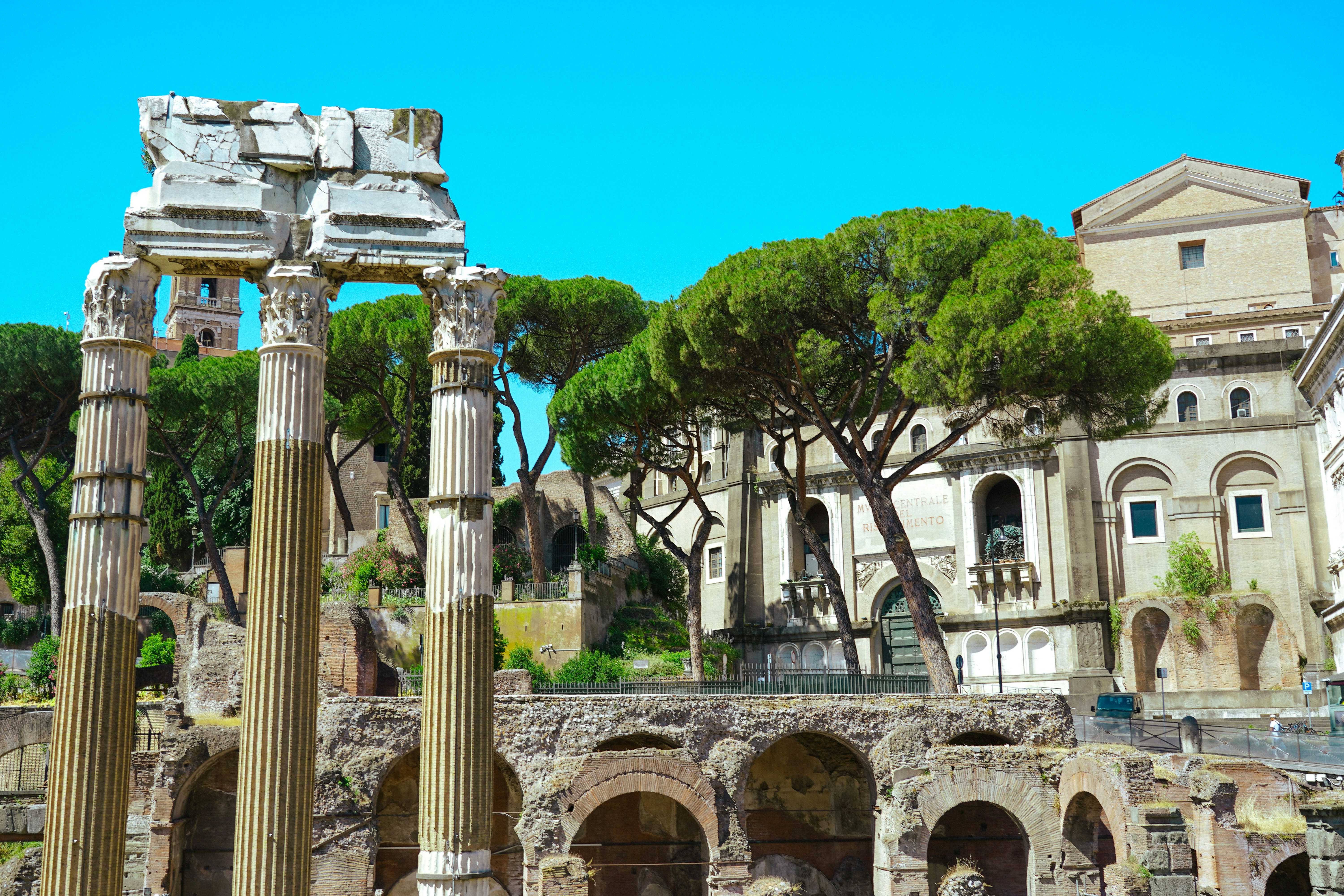 the ruins of a roman city with trees in the background