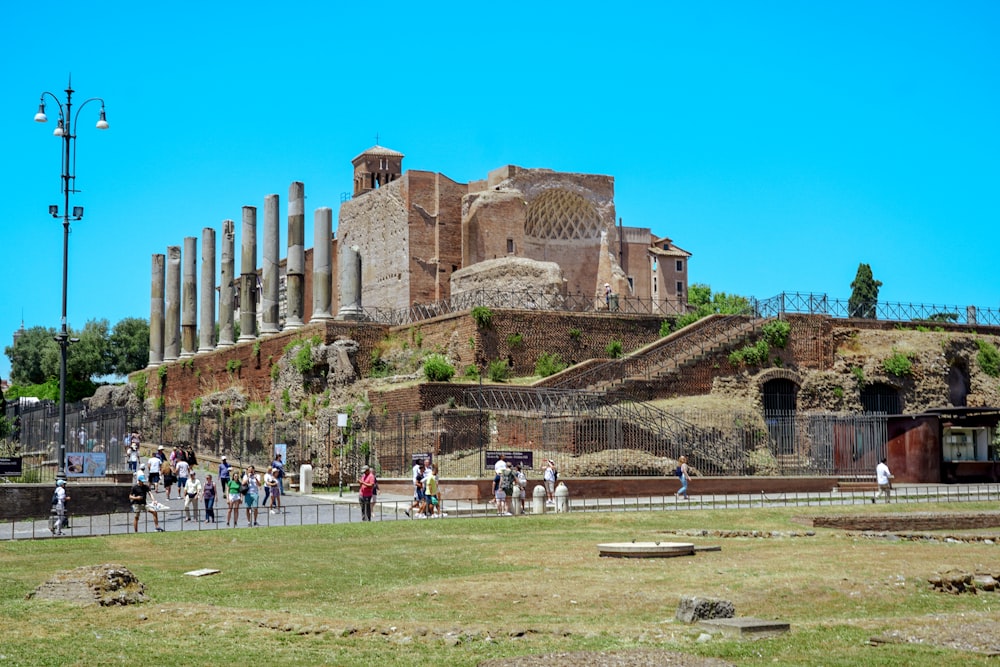 a group of people walking around a large building