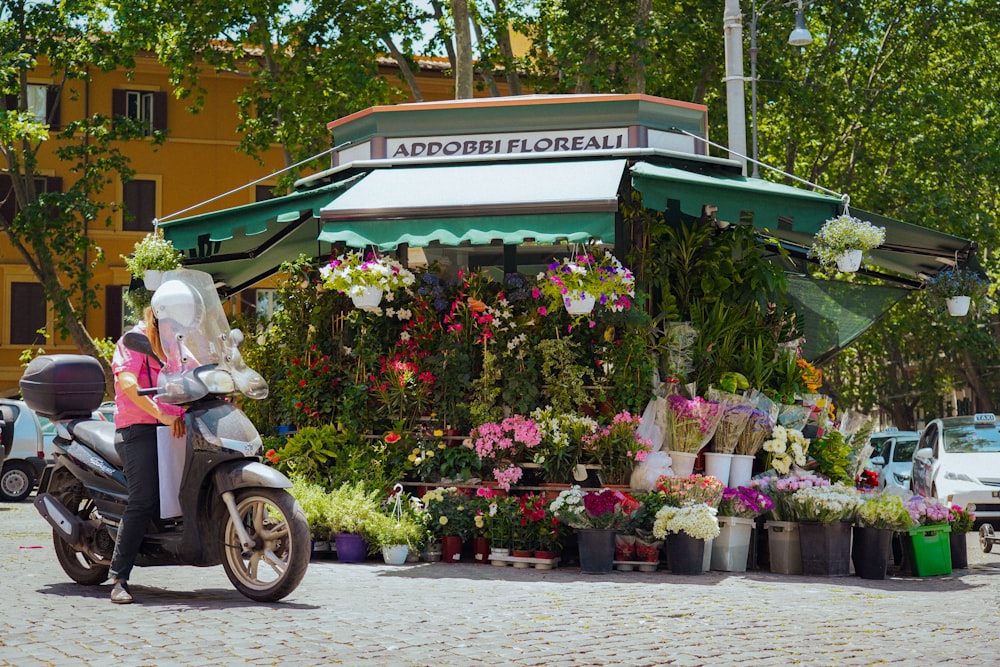 a motorcycle parked in front of a flower shop