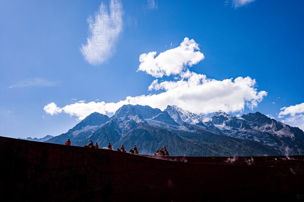 a group of people riding horses on top of a mountain