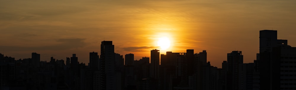 the sun is setting over a city skyline