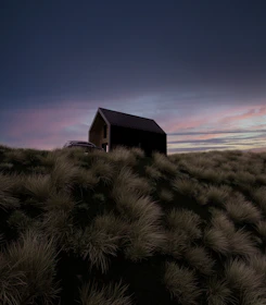 A minimalist, dark-toned cliffside villa silhouette under muted twilight.