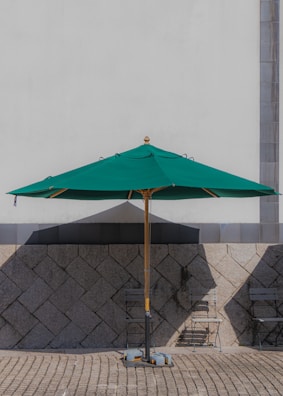 A stylish patio umbrella stand featured in an outdoor setting.