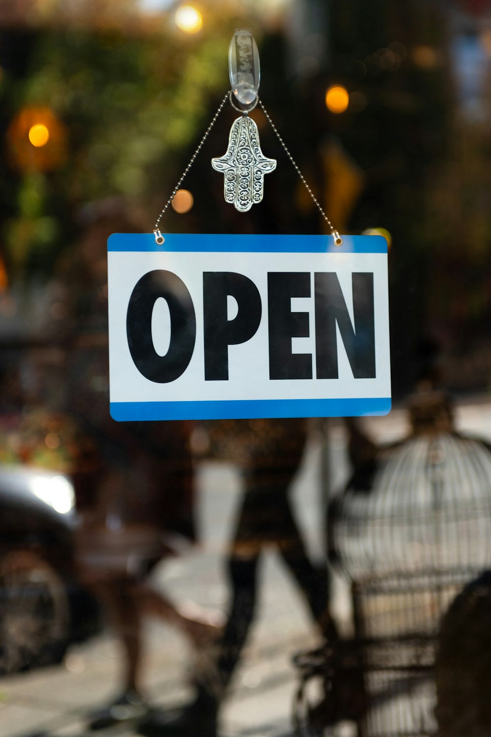 a sign that says open hanging from a window