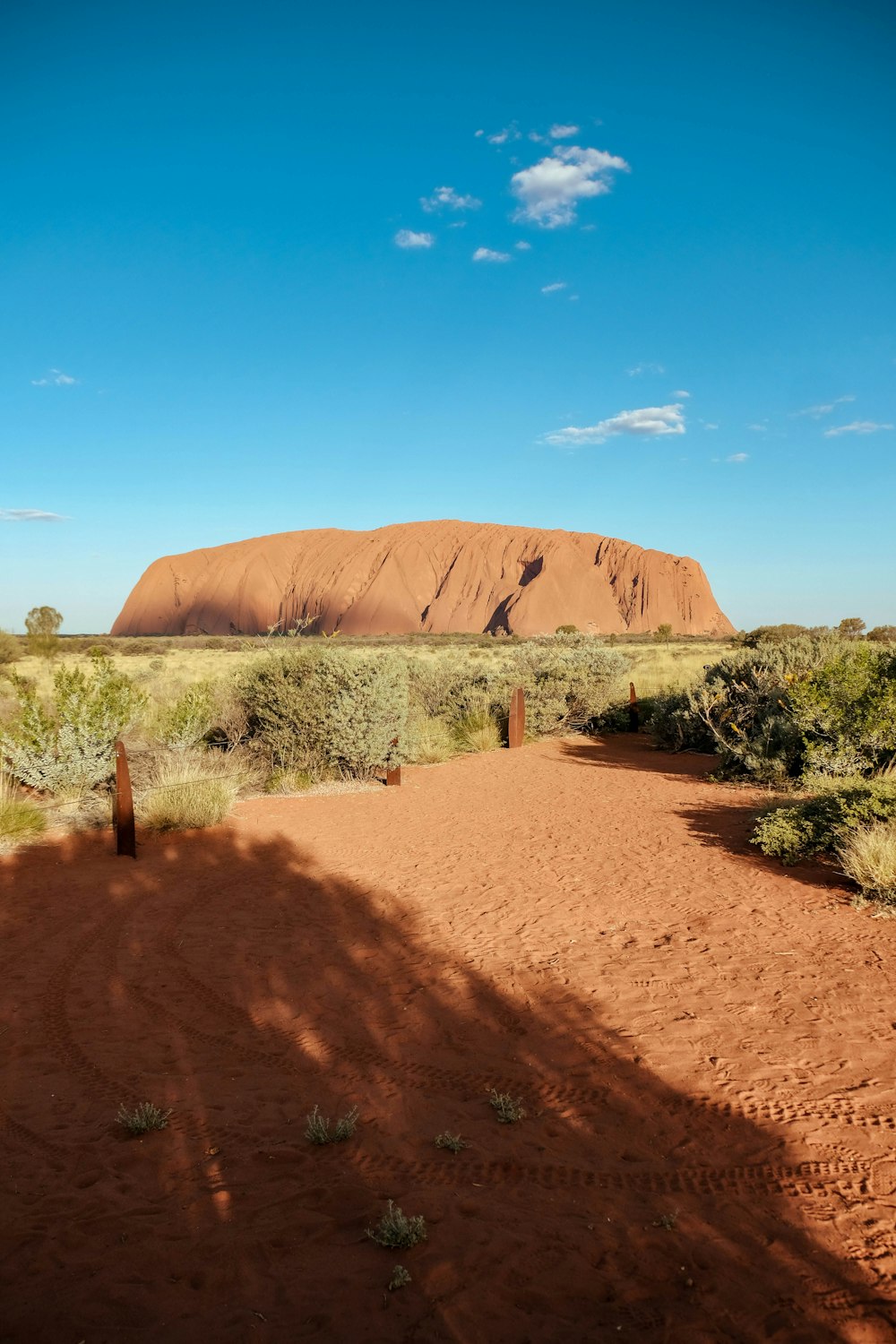 a large rock in the middle of a desert