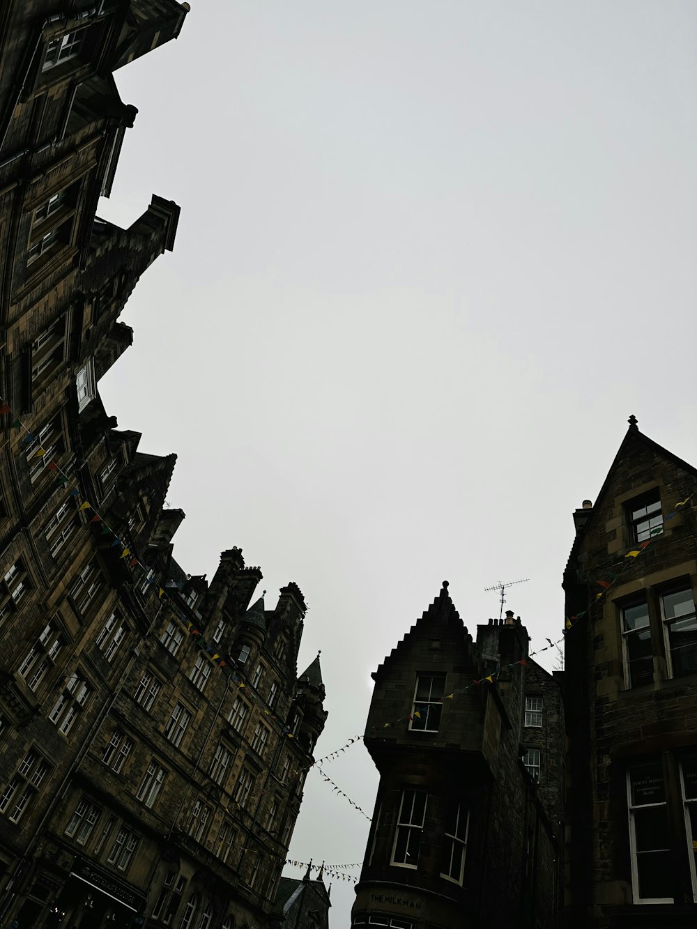 a clock tower towering over a city filled with tall buildings