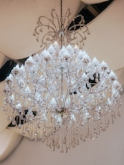 Chandelier with crystal details sparkling in a classic dining room.