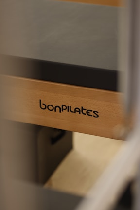 Close-up of reformer pilates equipment with a patient performing exercises.