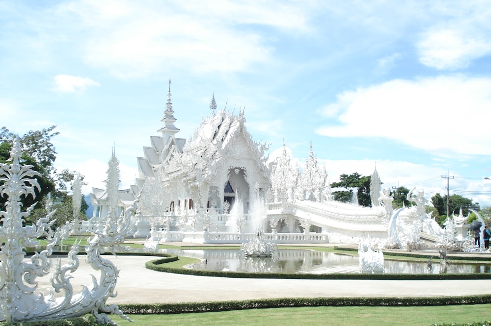 a large white building with a fountain in front of it