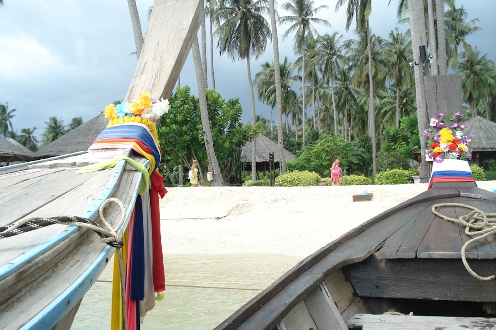 a boat on a beach with palm trees in the background