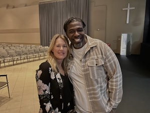 Couple attending a lively marriage workshop in a cozy church hall.