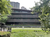 An exterior view of a contemporary building surrounded by greenery, emphasizing harmony with nature.