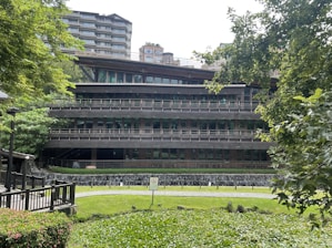 A modern hospital building surrounded by greenery, symbolizing sustainability.
