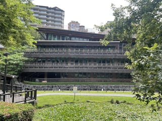 A modern eco-friendly residential building surrounded by greenery.
