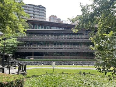 A modern eco-friendly building surrounded by greenery.