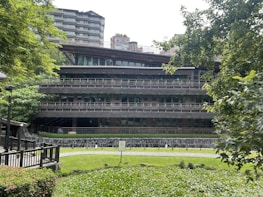 An exterior view of a contemporary building surrounded by greenery, emphasizing harmony with nature.