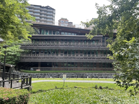 A modern building with a fire safety system visible, surrounded by green landscaping.