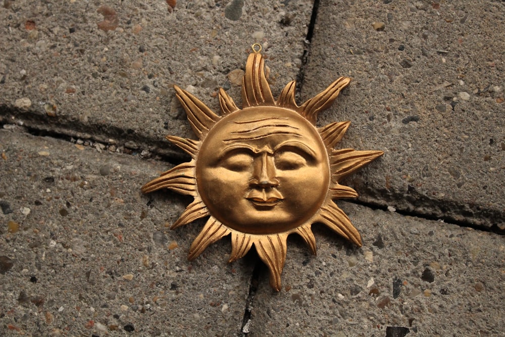 a sun face is on the sidewalk of a building