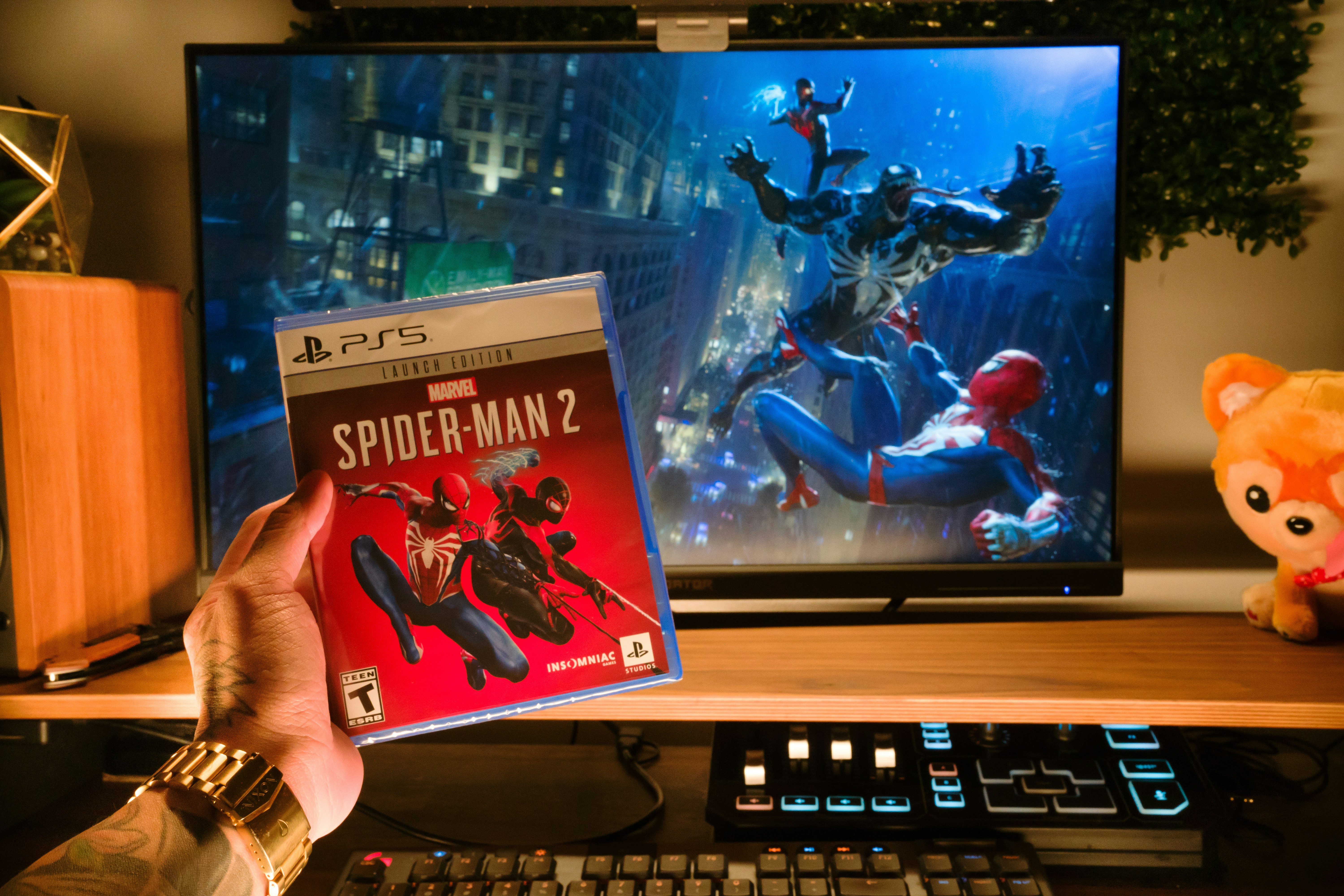 a person holding a video game in front of a television