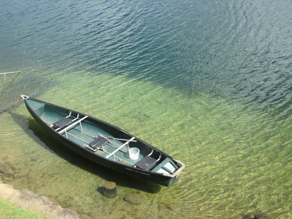 a small boat floating on top of a body of water