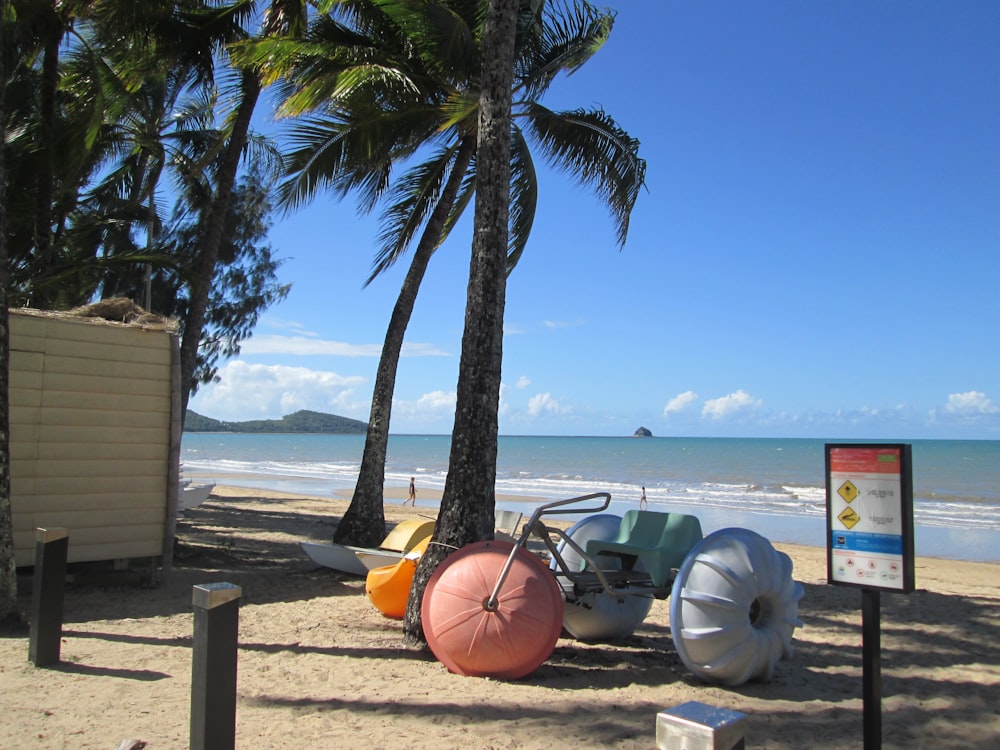 a beach with palm trees and beach chairs