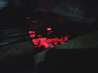 The Flammaease brush hanging neatly by a grill, glowing softly in the evening light.