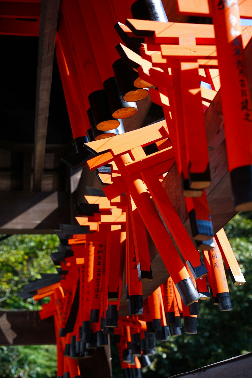 a bunch of orange sticks hanging from a ceiling