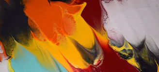 A vibrant dazzle art piece in progress, with copper brown and burnt orange splashes.
