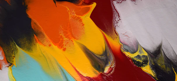A vibrant dazzle art piece in progress, with copper brown and burnt orange splashes.