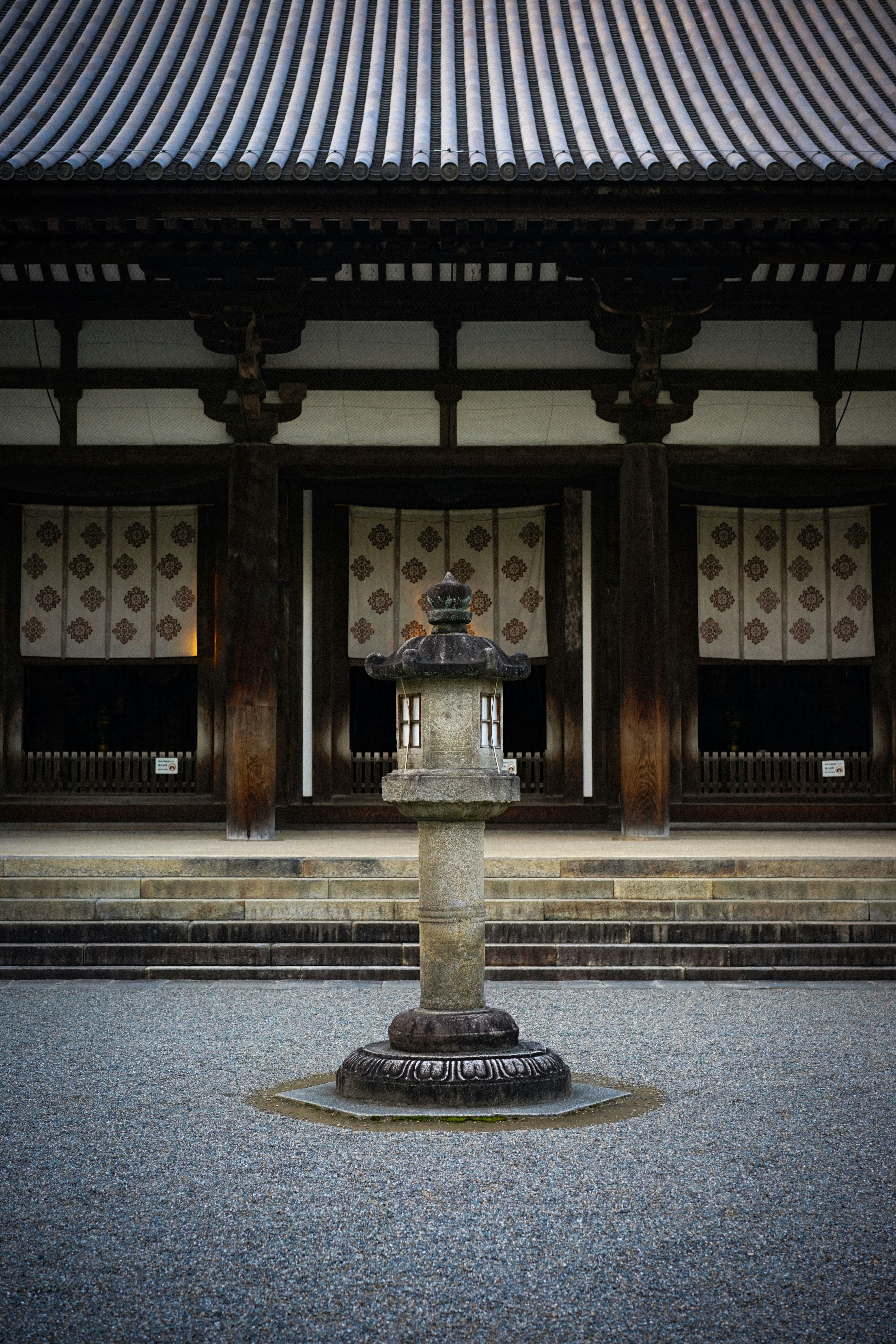 a stone fountain in front of a building