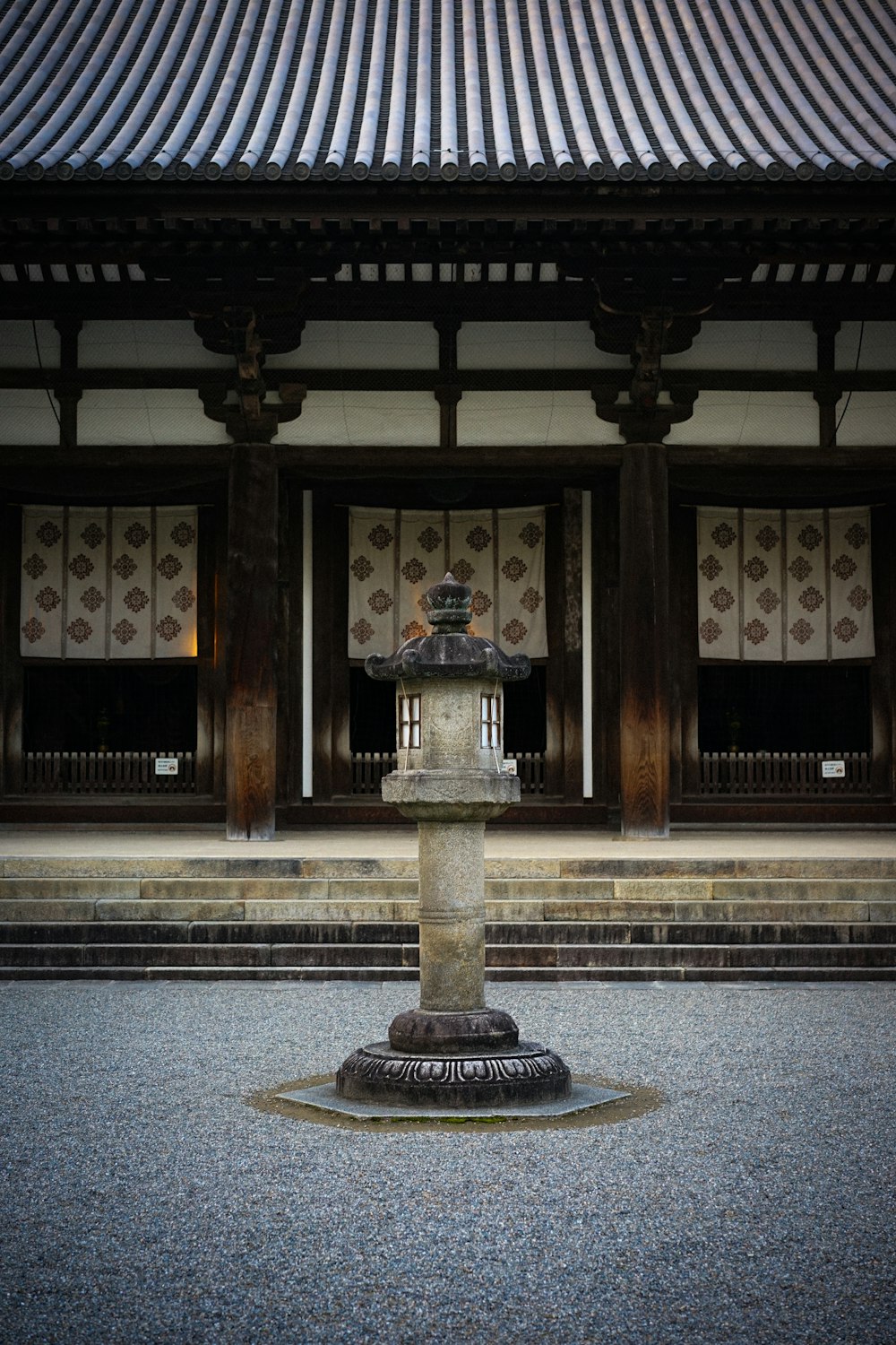 a stone fountain in front of a building