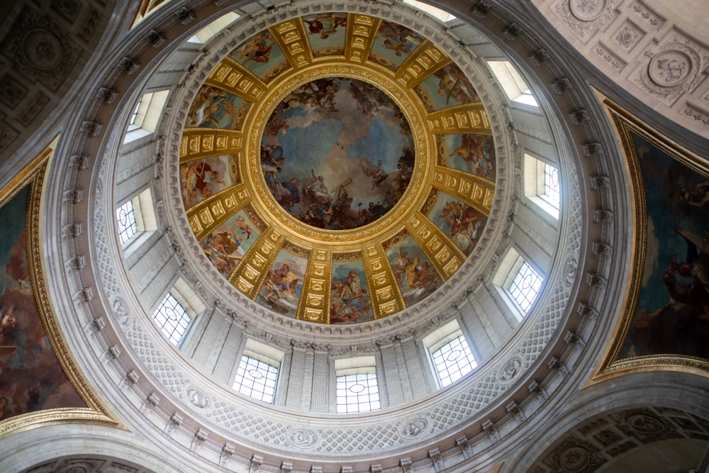 the ceiling of a building with a painting on it