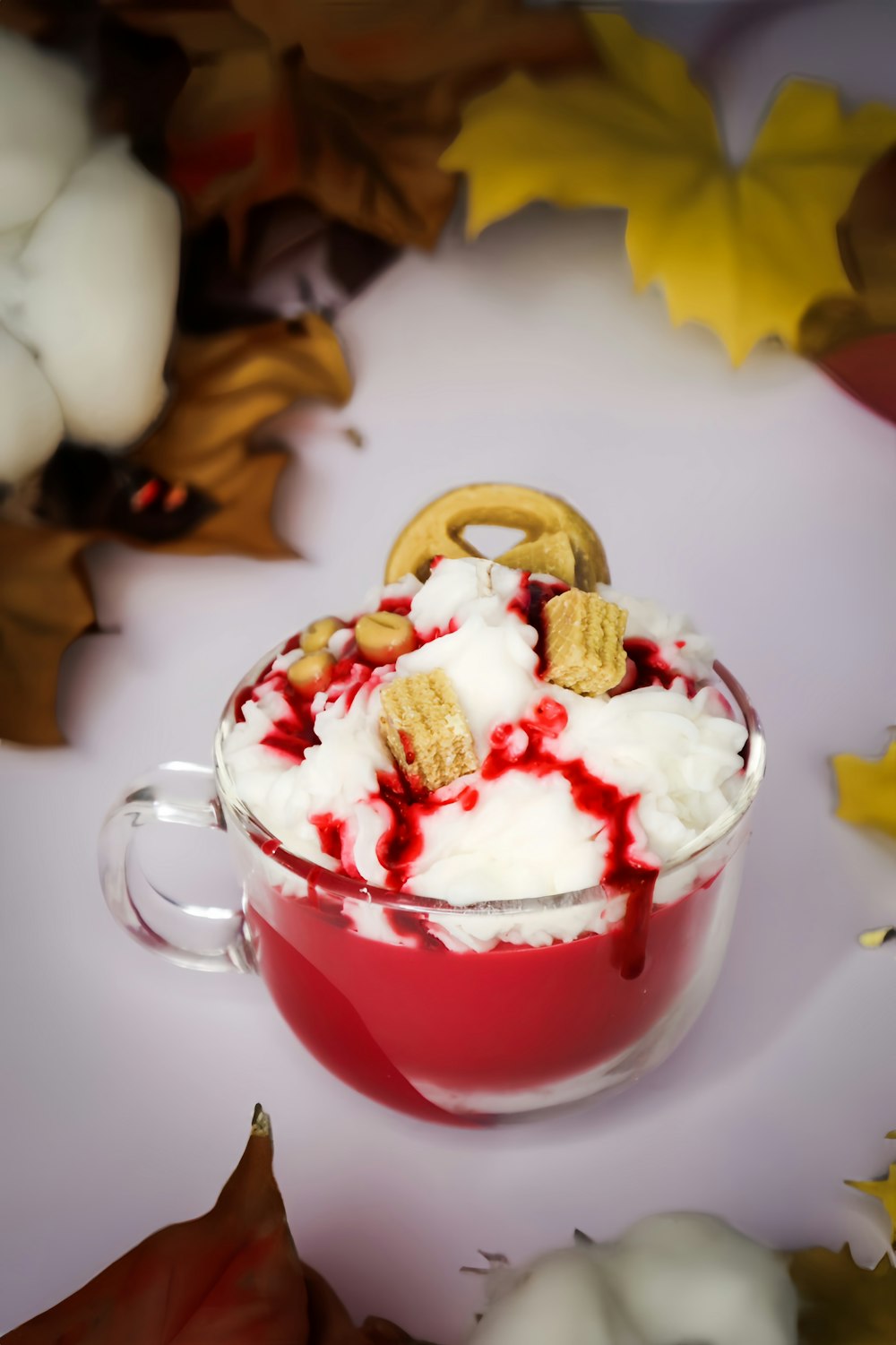 a cup of ice cream with a pretzel on top