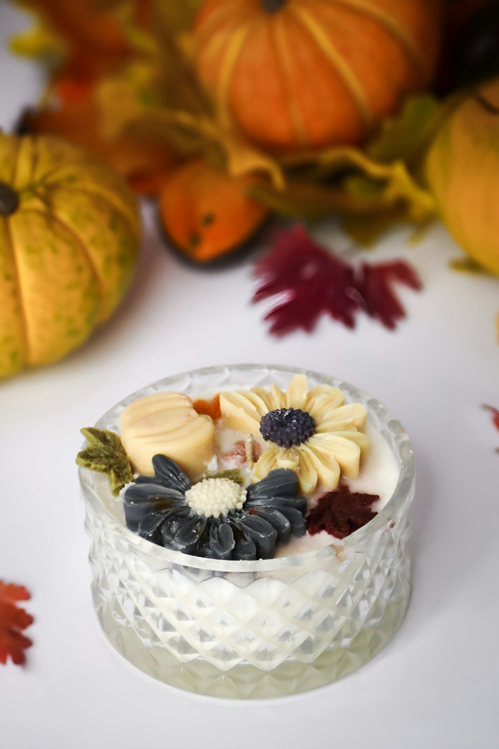 a small glass bowl filled with fruit on top of a table