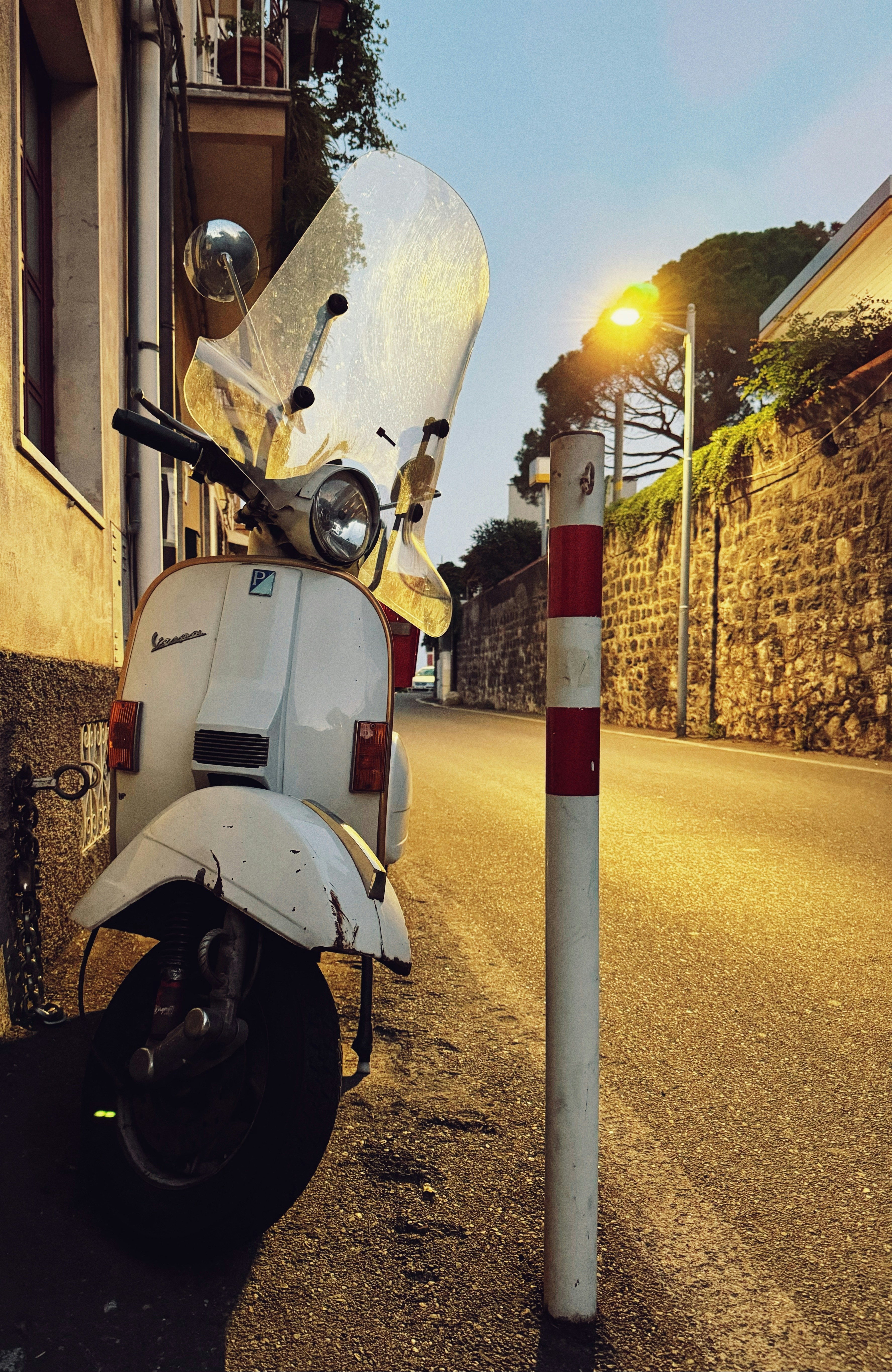 a scooter parked on the side of the road