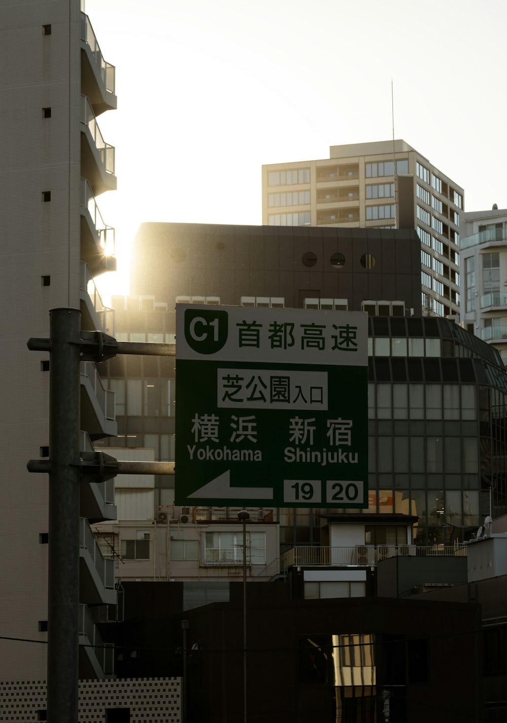 a street sign in a foreign language in front of a building