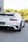 a white porsche sports car parked in front of a building