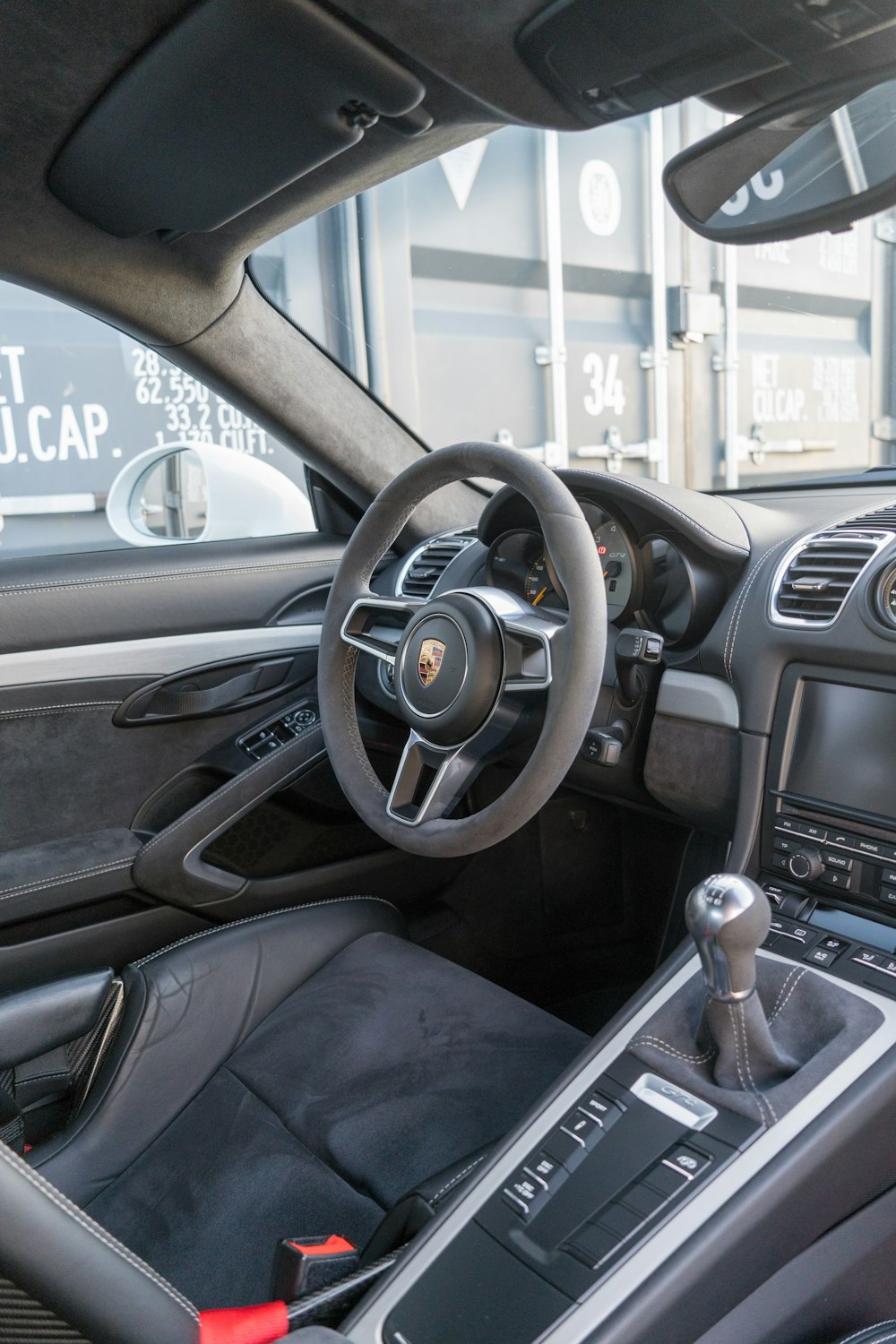 the interior of a car with a steering wheel and dashboard