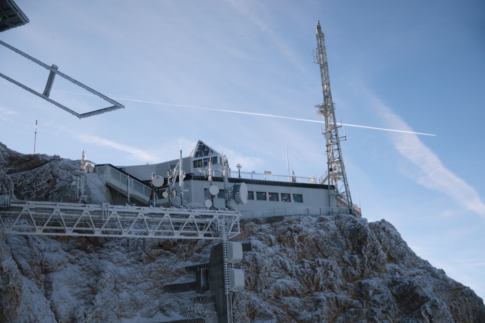 a building on top of a mountain covered in snow