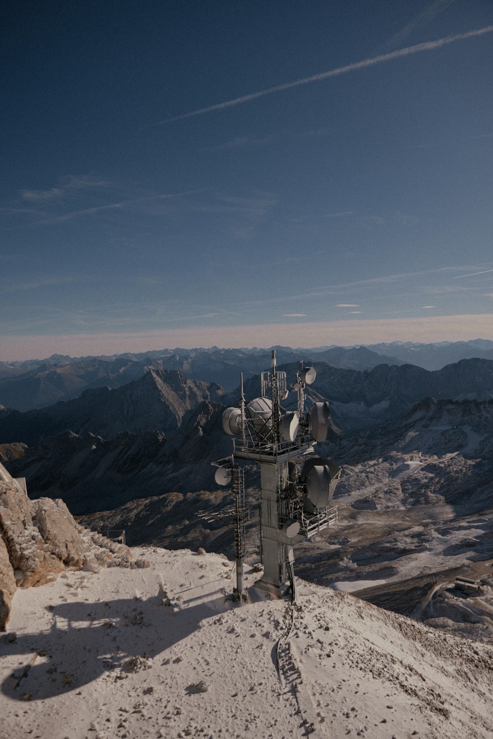 a person standing on top of a snow covered mountain