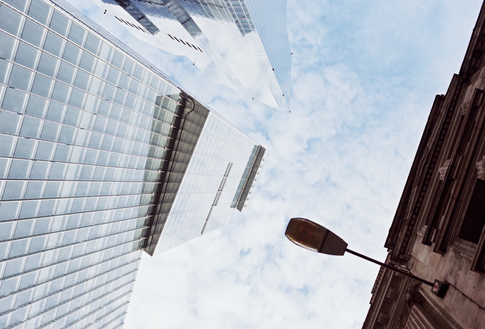 looking up at a street light and tall buildings