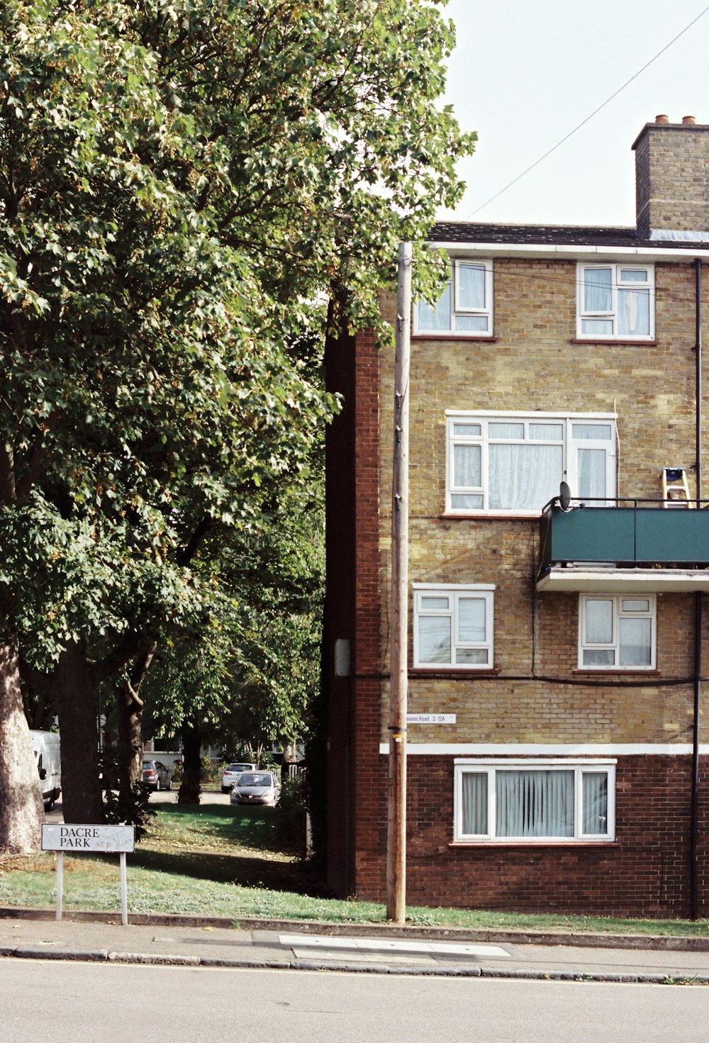 a tall brick building sitting on the side of a road