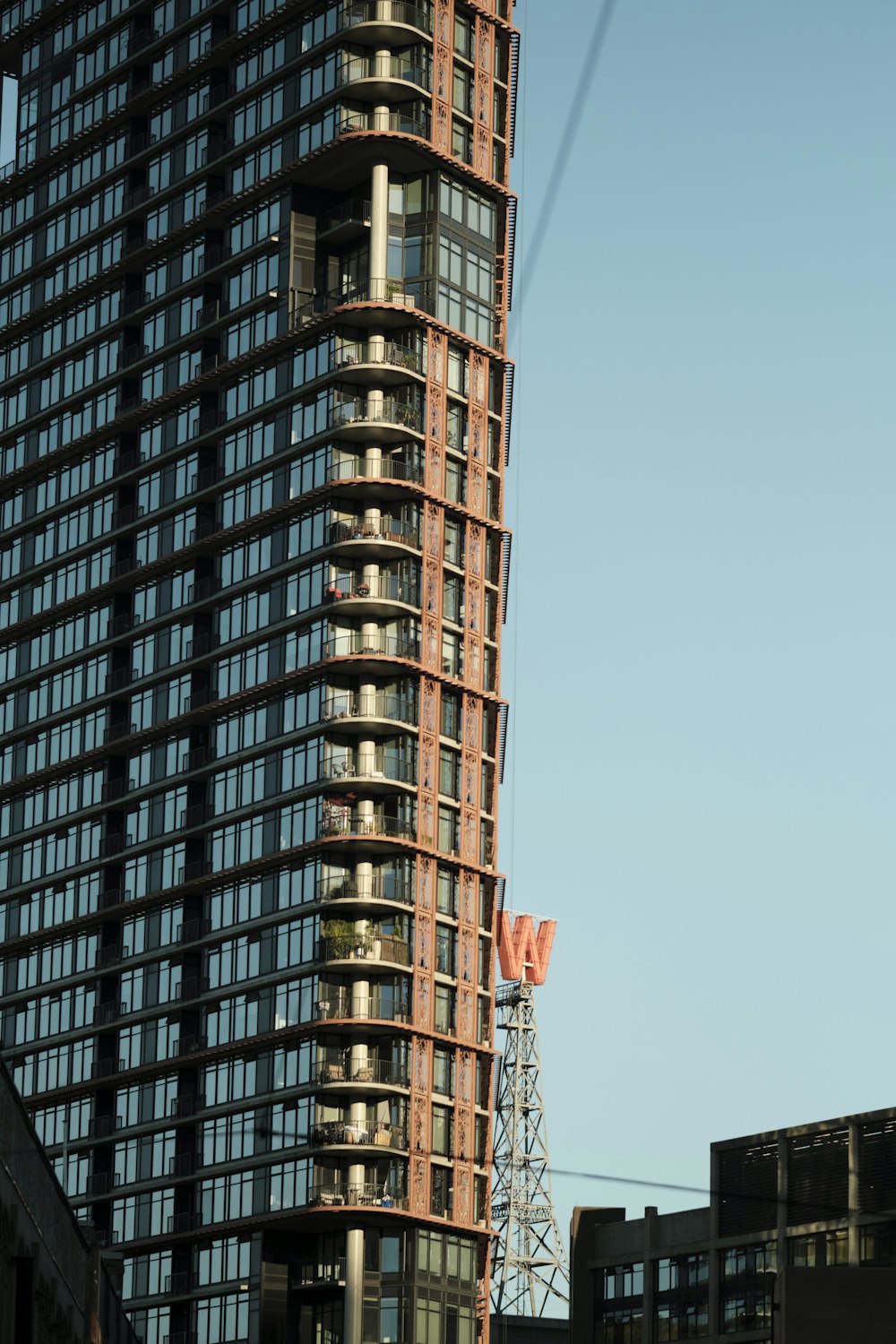 a tall building with lots of windows next to other buildings