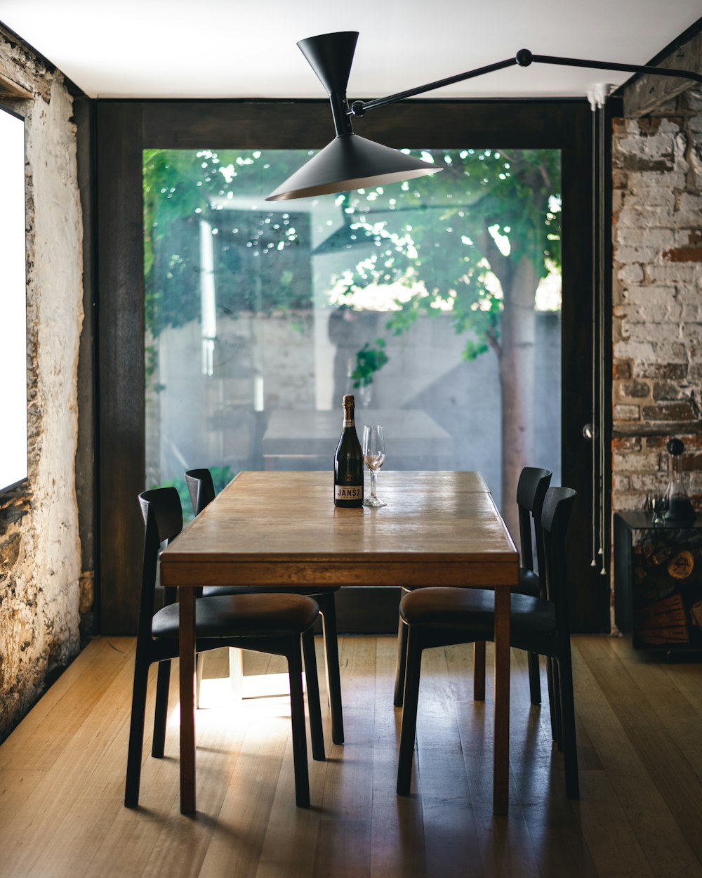 a dining room table with a bottle of wine on it