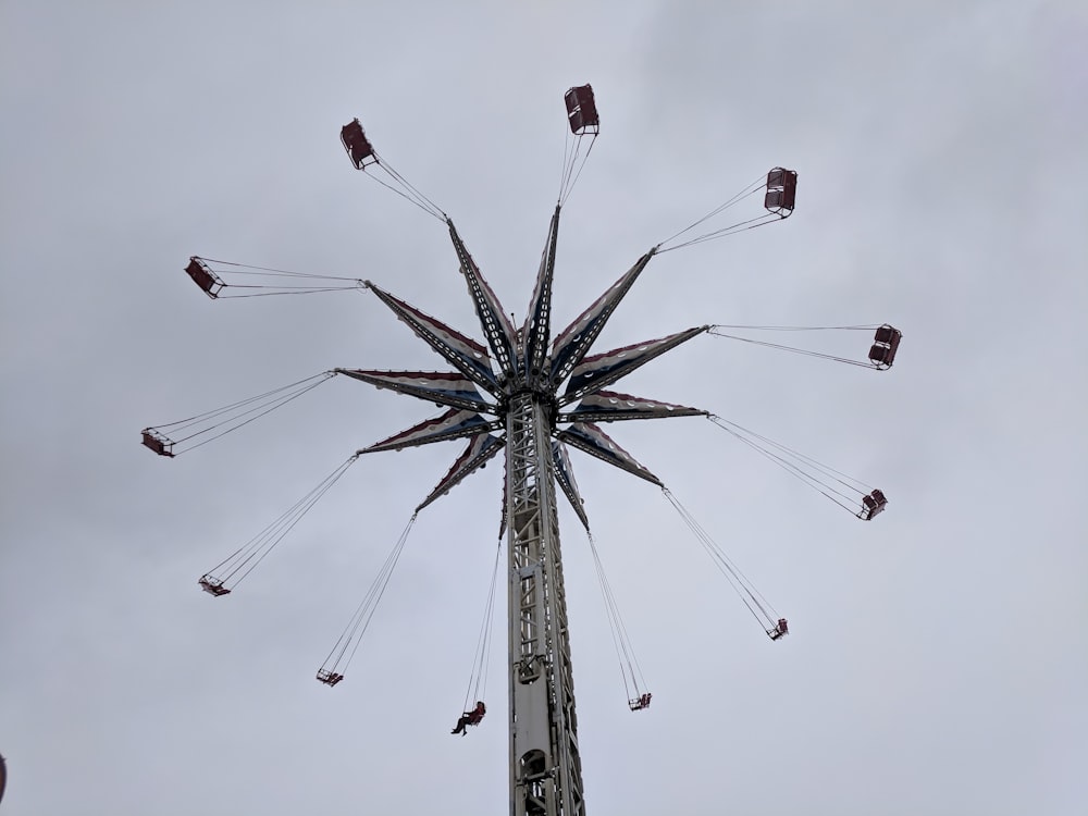 a ferris wheel with flags flying in the sky