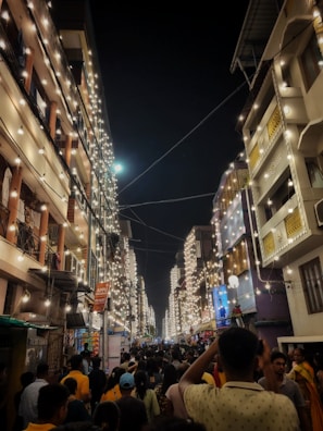 A bustling city street during a lively cultural festival at sunset