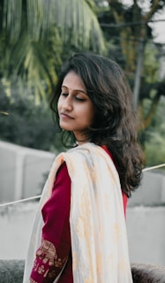 A serene woman meditating outdoors with colorful mystical patterns swirling around her.