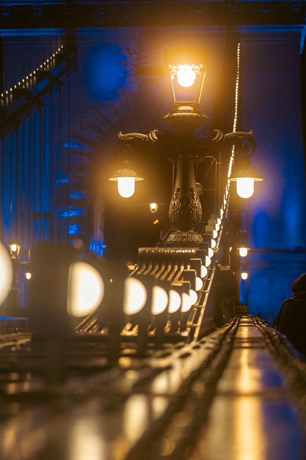 a light shines on a bridge at night