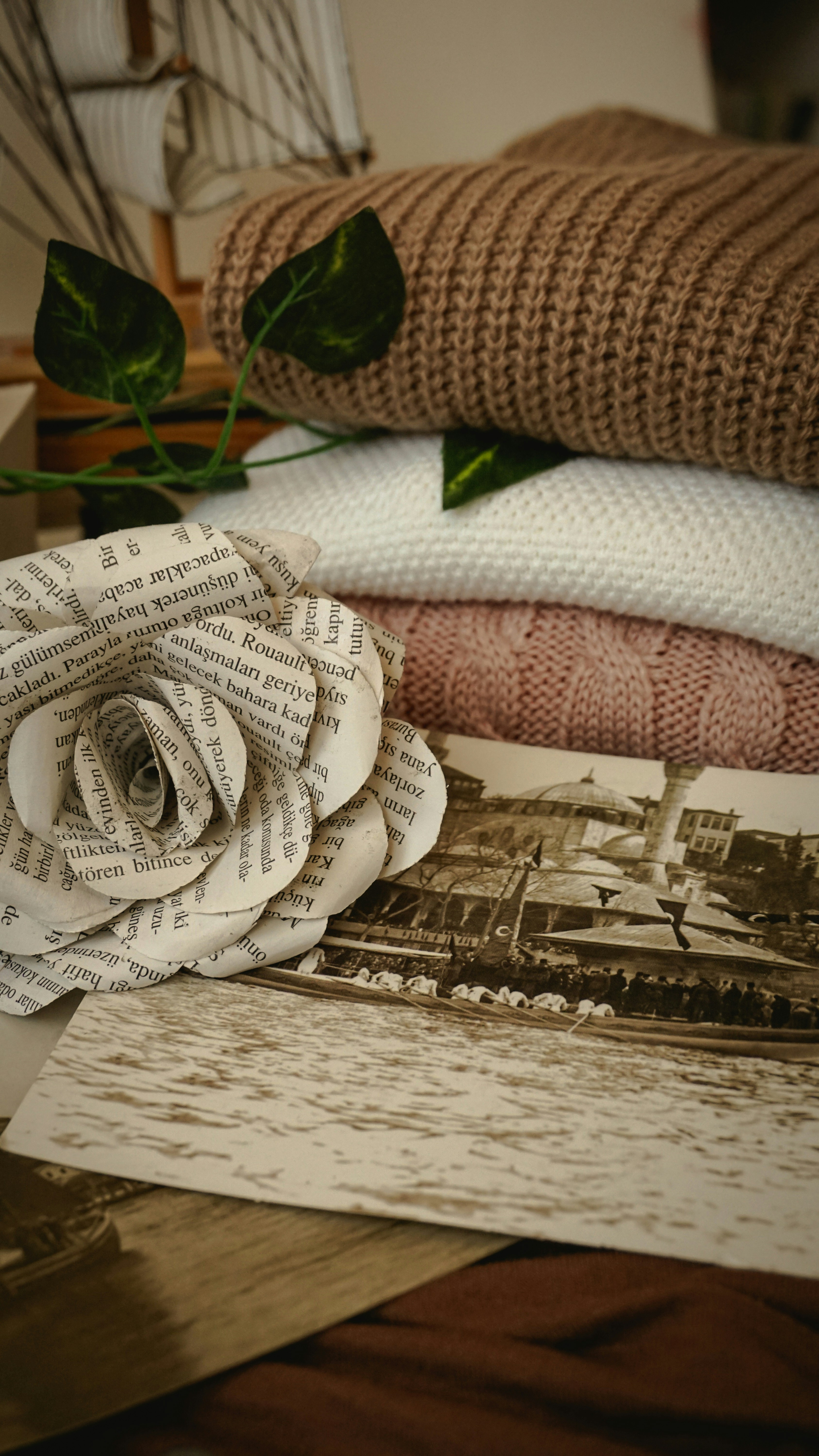 a rose sitting on top of a pile of books
